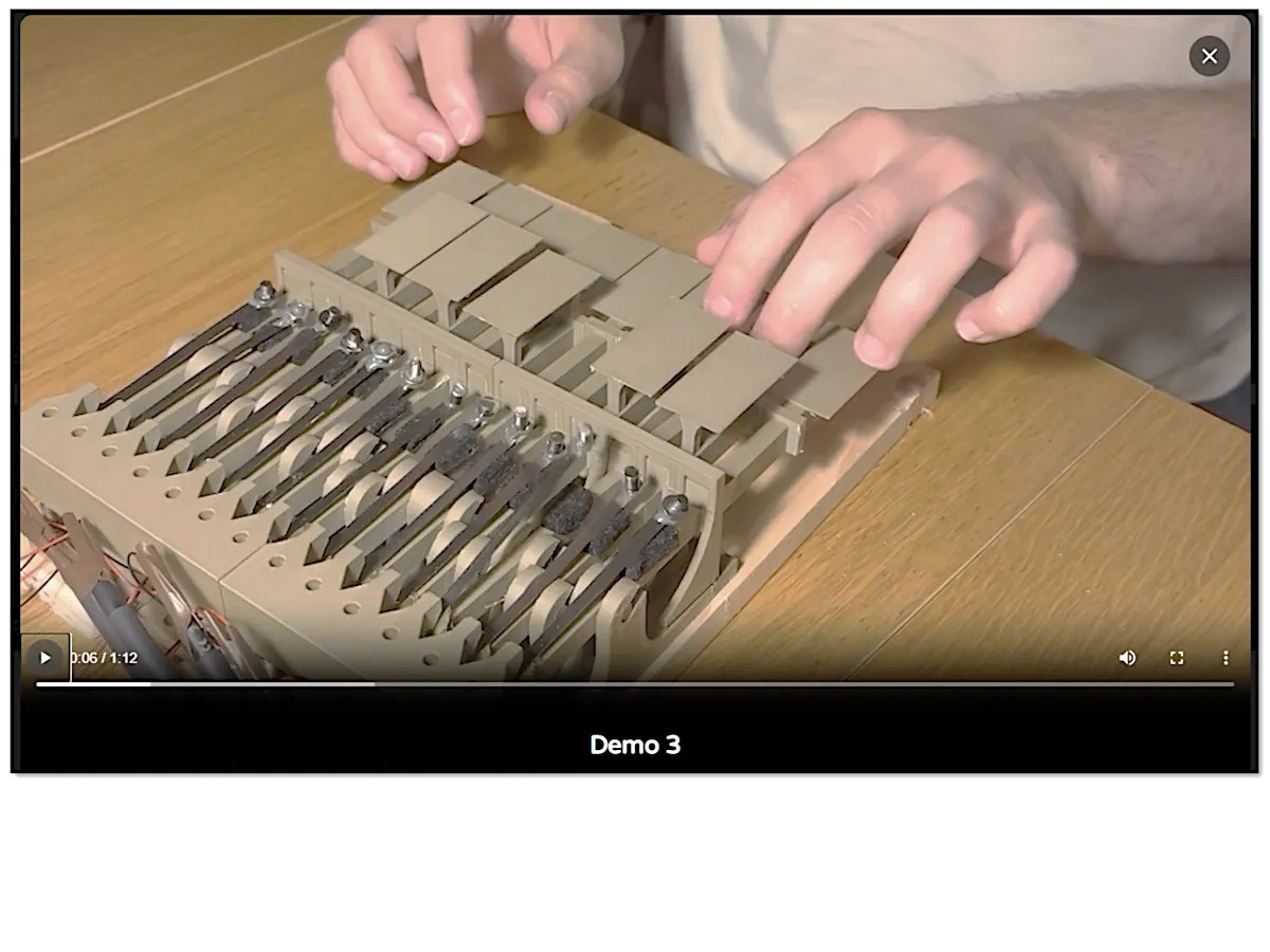 Working Orbiton keyboard prototype being played, with plain rectangular vibrating lamellas visible beneath the keys