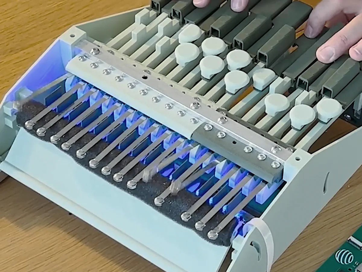 Orbiton keyboard prototype being played, using the riveted tip masses developed during the work